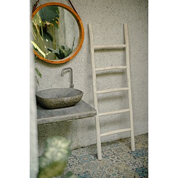 Een witte teakhouten decoratieladder, 150 cm hoog, 50 cm breed en 5 cm diep. Deze ladder heeft meerdere sporten met gelijke tussenafstanden en staat licht achterover geleund voor stabiliteit. Het teakhout is afgewerkt met een witte verf, die een frisse en